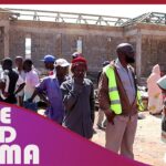 Construction site with gathered people.