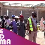 Construction site with gathered people.
